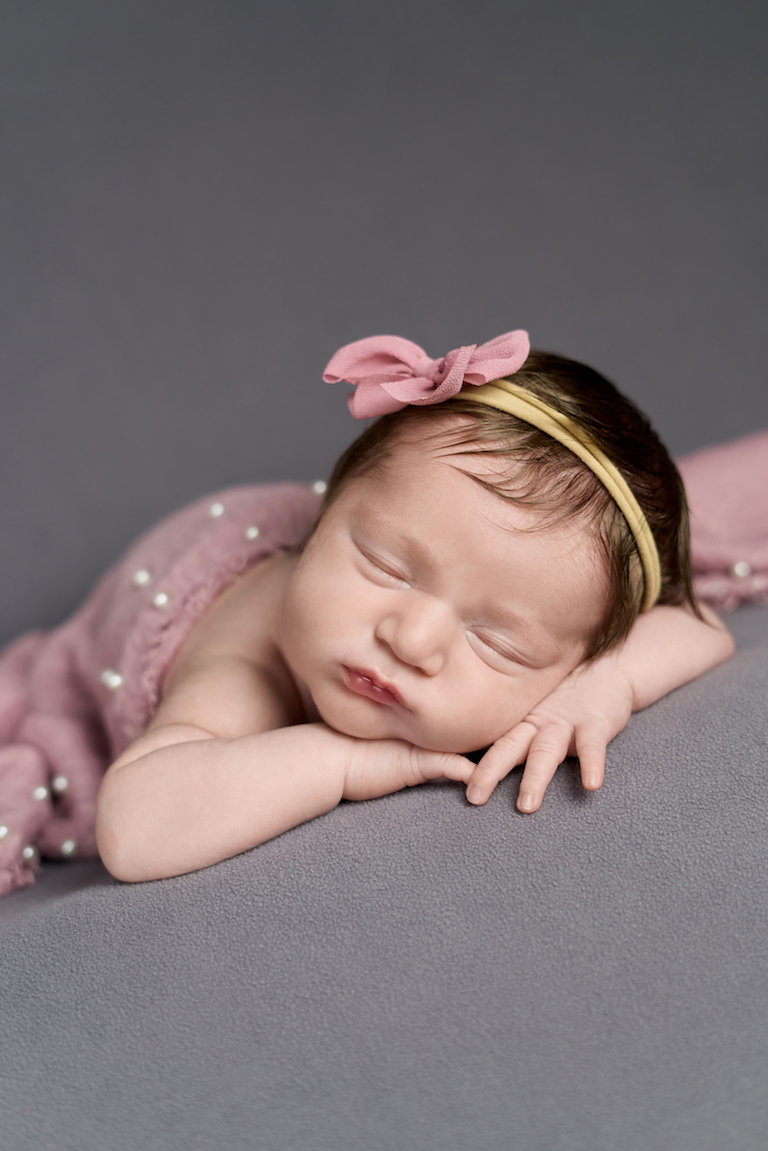 newborn baby girl in pink bow