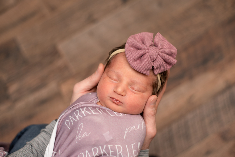 newborn baby in pink bow