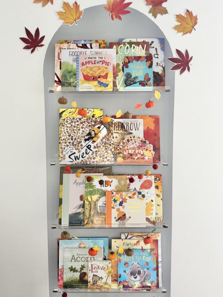 Our seasonal bookshelf filled with fall books for kids about autumn leaves, pumpkins, apples, acorns, and the changing seasons