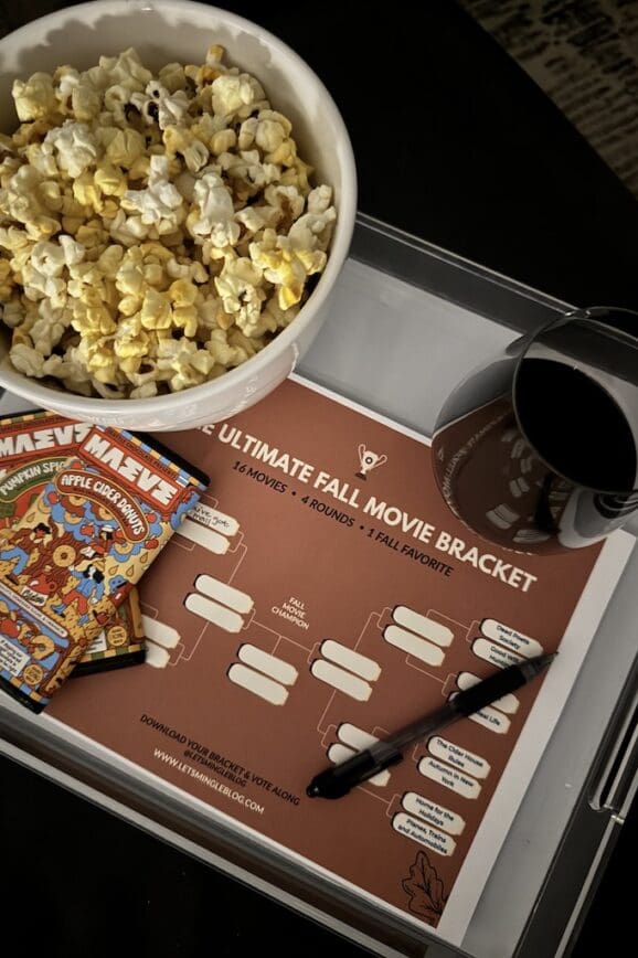 Printable fall movie bracket with popcorn, wine, candy and a pen for movie night