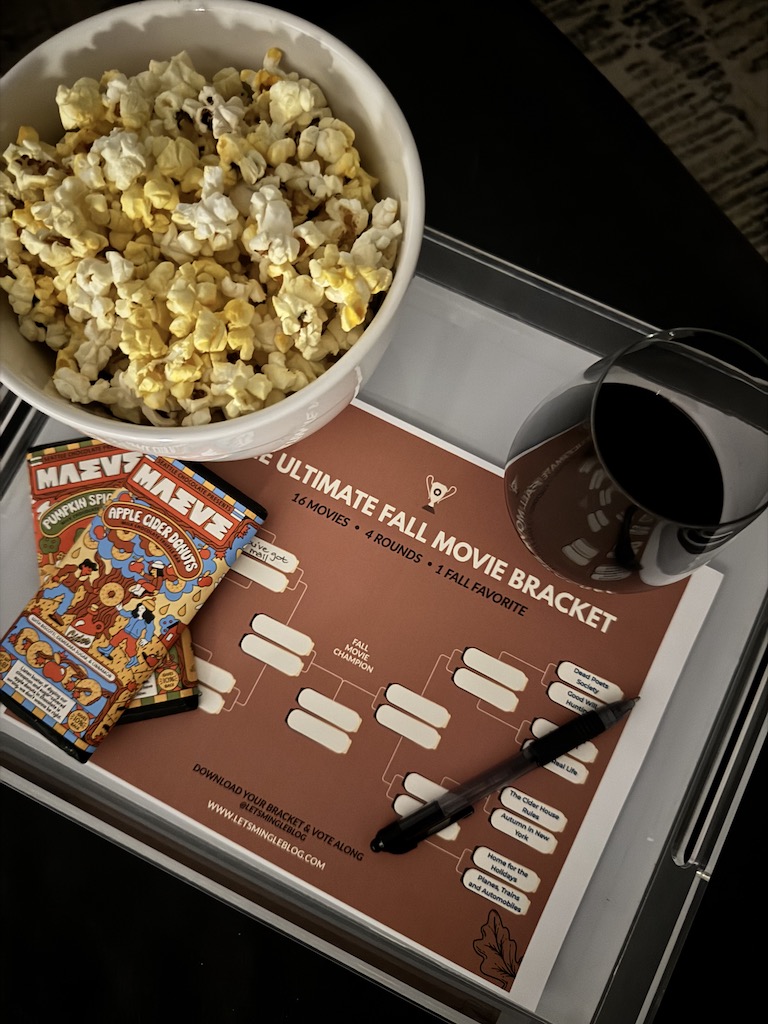 Printable fall movie bracket with popcorn, wine, candy and a pen for movie night